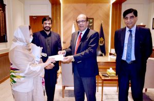 Deputy Chairman NAB, Mr Sohail Nasir along with others distributing cheques among affectees of Khyaban e Amin Housing Scheme.