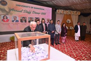 Vice Chancellor University of Jhang, Prof. Dr. Faheem Aftab, is selecting a raffle for free Umrah Tickets for employees at an Annual Dinner in honor of employees of scales 1 to 16 at University of Sargodha.