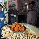 A vendor displays traditional sweet milk jalebi and dates, attracting people to enjoy the seasonal winter treat at Chowk Noonarian