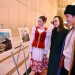 Participants take keen interest in photographs by Russian artists during a ceremony marking the People’s Unity Day of the Russian Federation at a local hotel