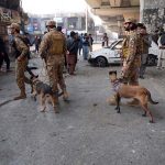 Security officials inspect the site of a suicide attack on the Federal Constabulary headquarters, where three FC soldiers were killed and 11 civilians injured