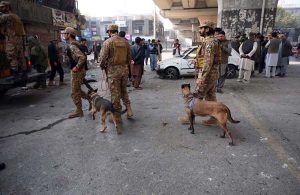 Security officials inspect the site of a suicide attack on the Federal Constabulary headquarters, where three FC soldiers were killed and 11 civilians injured