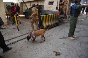 Security officials inspect the site of a suicide attack on the Federal Constabulary headquarters, where three FC soldiers were killed and 11 civilians injured