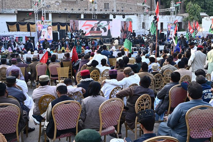 A large crowd of party workers watches and listens to PPP Chairman Bilawal Bhutto Zardari’s live speech on a big screen during the 58th PPP Foundation Day at Dialdas Club