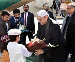 Upon arrival at Gilgit Airport, President Asif Ali Zardari being presented a bouquet.