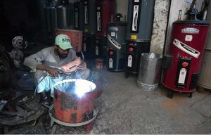 A worker making water geysers at his shop as demand rises with the onset of the winter season.