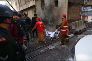 Rescue and security personnel collect evidence at the scene of a suicide attack on the Federal Constabulary headquarters, where three FC soldiers were killed and 11 civilians injured