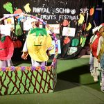 Students are performing tableau on the stage during fruits festival at local School