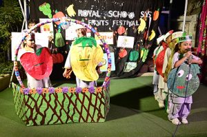 Students are performing tableau on the stage during fruits festival at local School