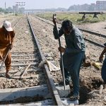 Railway workers busy repairing the rail track near the railway station