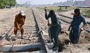 Railway workers busy repairing the rail track near the railway station