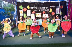 Students are performing tableau on the stage during fruits festival at local School