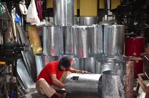 A worker making water geysers at his shop as demand rises with the onset of the winter season.