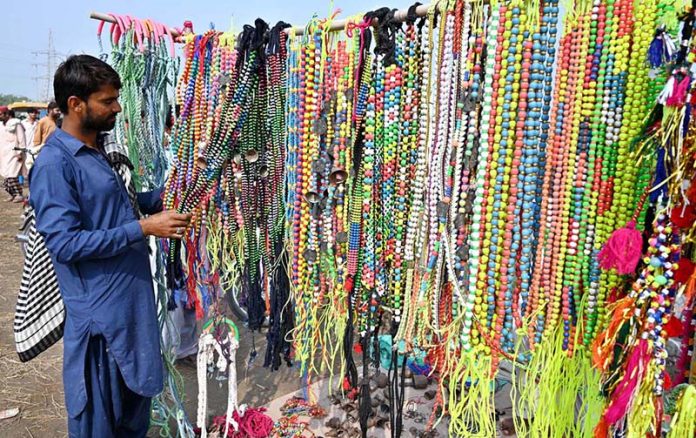 A roadside vendor displays animal ornaments for sale near the Bypass Road Livestock Market