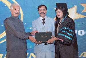 Defence Minister Khawaja Muhammad Asif distributes certificates and shields to successful students during the 14th convocation of Shadab Girls College