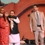 Federal Minister for National Heritage and Culture, Aurangzeb Khan Khichi, presenting a traditional shawl to a folk artist as a mark of respect during the inaugural ceremony of the ten-day annual folk festival “Lok Mela 2025” at Lok Virsa