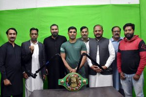 Pakistani boxer Muhammad Ali in a group photograph with the employees during his visit to the Associated Press of Pakistan's (APP) bureau office in Lahore. Muhammad Ali recently won the WBC Asia Welterweight Championship by defeating an Indian boxer.