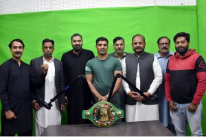 Pakistani boxer Muhammad Ali in a group photograph with the employees during his visit to the Associated Press of Pakistan's (APP) bureau office in Lahore. Muhammad Ali recently won the WBC Asia Welterweight Championship by defeating an Indian boxer.
