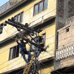 WAPDA electricians repair damaged electricity wires on a pole to restore power in the Banni area of the old city in twin cities