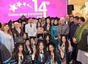 Defense Minister Khawaja Muhammad Asif in a group photograph with successful students and faculty members during the 14th convocation of Shadab Girls College