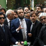 Minister for Information and Broadcasting, Attaullah Tarar talking to media persons outside court.