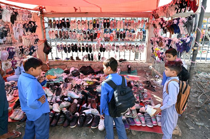 Students looking to buy used old shoes at old Bus Stand Road