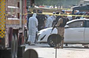 Security personnel conducting a search operation outside the District Judicial Complex following a terrorist blast that, according to initial reports, left twelve people dead and twenty others injured.