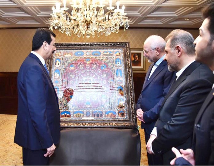 H.E. Dr. Mohammad Bagher Ghalibaf, Speaker of the Islamic Consultative Assembly of Iran presenting a painting to Acting President Syed Yousuf Raza Gilani at Aiwan-e-Sadr