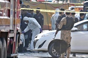 Security personnel conducting a search operation outside the District Judicial Complex following a terrorist blast that, according to initial reports, left twelve people dead and twenty others injured.