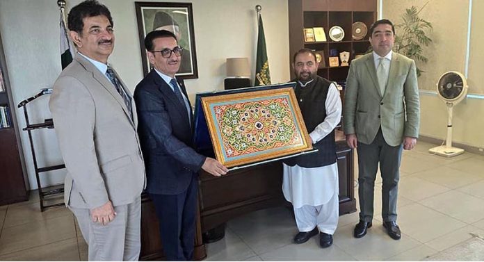 Ambassador of Tajikistan Sharifzoda Yusuf Toirali presenting traditional Tajik handicraft gift to the Federal Minister for National Heritage and Culture Division Aurangzeb Khan Khichi