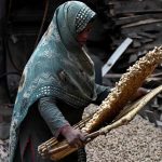 Female workers cleaning peanuts before supply to different markets at their workplace in the provincial capital.