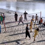 Youngsters playing Volleyball game at Rice Canal