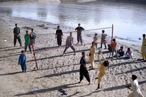 Youngsters playing Volleyball game at Rice Canal