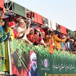 Foreigners wave to participants during the Welcome Christmas Rally