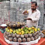 A vendor seen selling sweet potatoes at a roadside stall in the city