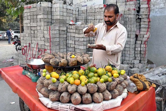 A vendor seen selling sweet potatoes at a roadside stall in the city