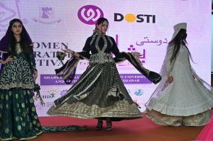 Art and Design students perform a cultural wedding-themed show on stage during the closing ceremony of the 3rd edition of the Dosti Peshawar Women’s Literature Festival 2025 at SBBWU.