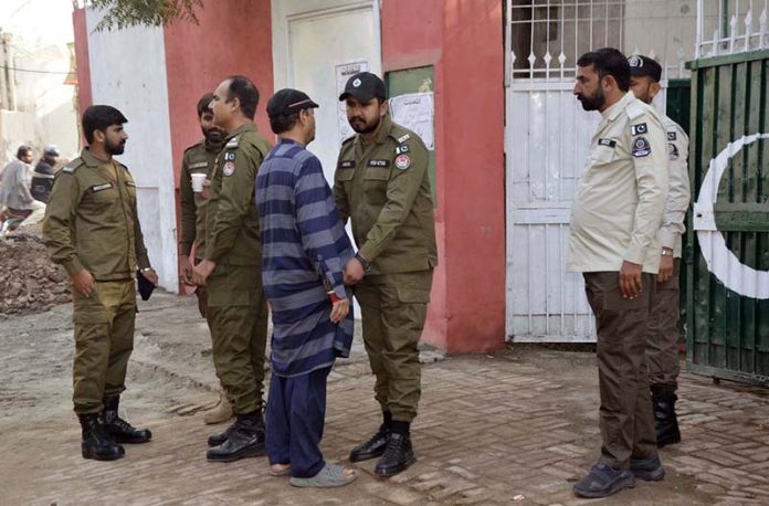 Security officials thoroughly checking voters before allowing entry into the polling station premises during the by-elections 2025