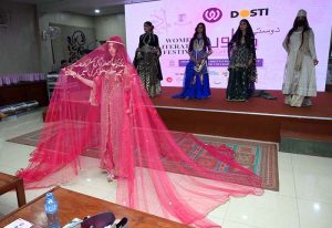 Art and Design students perform a cultural wedding-themed show on stage during the closing ceremony of the 3rd edition of the Dosti Peshawar Women’s Literature Festival 2025 at SBBWU.