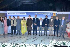 CEO of Roots Millennium Multan Campus, Dr. Faisal Mushtaq, presents a commemorative shield to Senate Chairman Syed Yusuf Raza Gillani