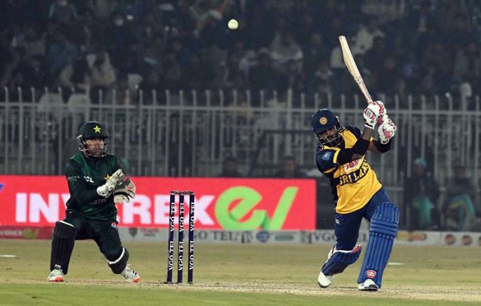 Sri Lankan batter Wanindu Hasaranga plays a shot during the T20I Tri-Nation Series match between Sri Lanka and Pakistan at Pindi Cricket Stadium