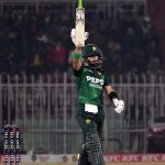 Pakistani batter Sahibzada Farhan raises his bat to celebrate his fifty during the Pakistan T20I Tri-Nation Series cricket match between Zimbabwe and Pakistan at Pindi Cricket Stadium