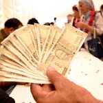 Indian Sikh pilgrims exchanging indian currency into Pakistani rupees after their arrival in Pakistan after crossing the India-Pakistan Wagah Border on the eve of celebrations marking the birth anniversary of Guru Nanak, the founder of Sikhism. Nearly two thousand Sikh pilgrims from India entered Pakistan in the first major crossing since deadly clashes in May led to the closure of the land border between the two neighbouring countries