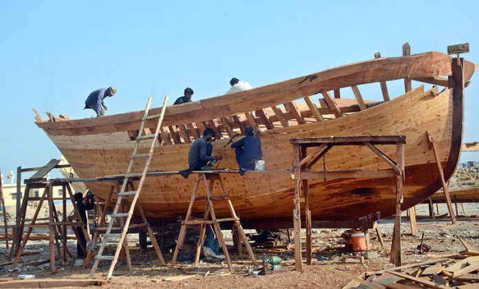 Workers preparing a new fishing boat in Ibrahim Hyderi, highlighting the traditional craftsmanship that sustains one of Karachi’s oldest fishing villages