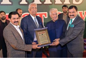 Senior Pastor Anwar Afzal presenting a shield to Defense Minister Khawaja Muhammad Asif at prayer ceremony for the Christian community at City Ground
