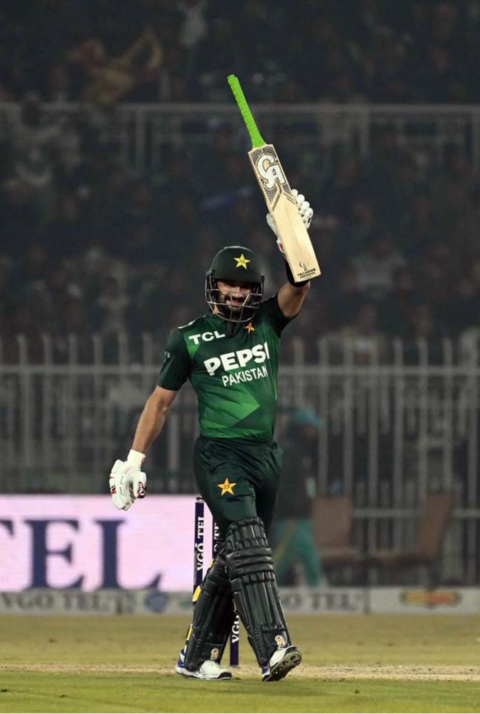Pakistani batter Sahibzada Farhan raises his bat to celebrate a half-century during the T20I Tri-Nation Series match between Sri Lanka and Pakistan at Pindi Cricket Stadium
