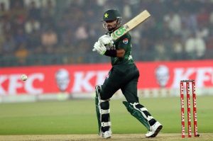 Pakistan’s batter Babar Azam raises his bat to acknowledge the crowd after completing his fifty during waving bat after completed fiffty during the third T20 international cricket match between Pakistan and South Africa at the Gaddafi Stadium.