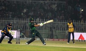 Pakistani batter Sahibzada Farhan raises his bat to celebrate a half-century during the T20I Tri-Nation Series match between Sri Lanka and Pakistan at Pindi Cricket Stadium