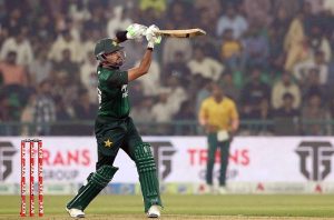 Pakistan’s batter Babar Azam raises his bat to acknowledge the crowd after completing his fifty during waving bat after completed fiffty during the third T20 international cricket match between Pakistan and South Africa at the Gaddafi Stadium.