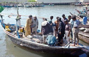 A fisherman unloads fish in Ibrahim Hyderi supply to the city